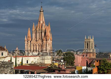 Church and cityscape under cloudy sky, with a hot air balloon in the distance; San Miguel de Allende, Guanajuato, Mexico View Large Photo Image Stock Photograph - Church and cityscape under cloudy sky, with a hot air balloon in the distance; San Miguel de Allende, Guanajuato, Mexico. Fotosearch
