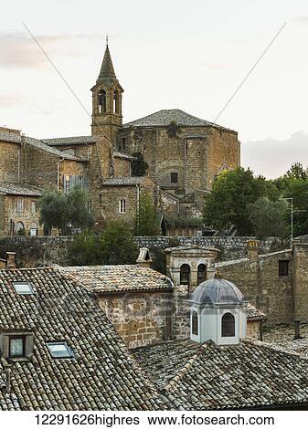 Stock Photograph - Church with bell tower and rooftops; Orvieto, Umbria, Italy. Fotosearch
