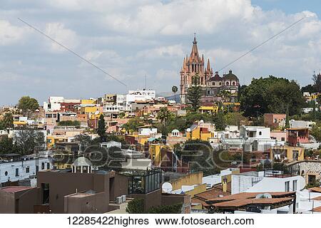 Stock Photograph - Cityscape with parish church in the distance; San Miguel de Allende, Guanajuato, Mexico. Fotosearch