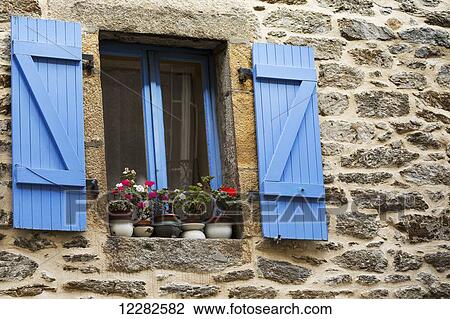 Close Up Of Colourfully Painted Blue Shutters And Window Frame On