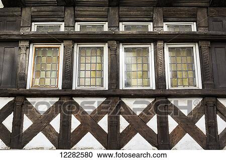 Close up of half timbered wooden structure and details on the side of a building with stained glass windows; Carhaix Plouger, Brittany, France View Large Photo Image Stock Image - Close up of half timbered wooden structure and details on the side of a building with stained glass windows; Carhaix Plouger, Brittany, France. Fotosearch