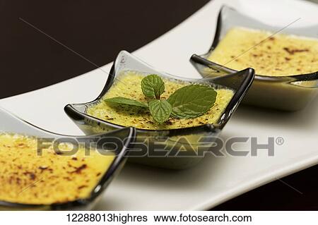 Stock Photograph - Close up of plate of three creme brulees; Ankara, Turkey. Fotosearch