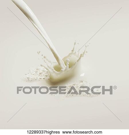 Stock Photograph - Close up of poured milk splashing; Toronto, Ontario, Canada. Fotosearch
