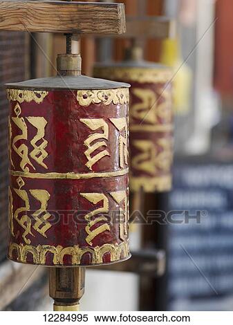 Stock Photography - Close up of red and gold buddhist prayer wheel; Paro, Bhutan. Fotosearch