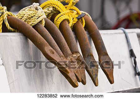 Stock Image - Close up of rusted iron hooks on the edge of a fishing boat, Sand Point, Popof Island, Southwestern Alaska, USA, summer. Fotosearch