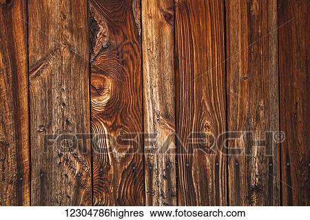 Stock Photograph - Close up of the knots and grain of wooden wall of a barn; Waterloo, Quebec, Canada. Fotosearch