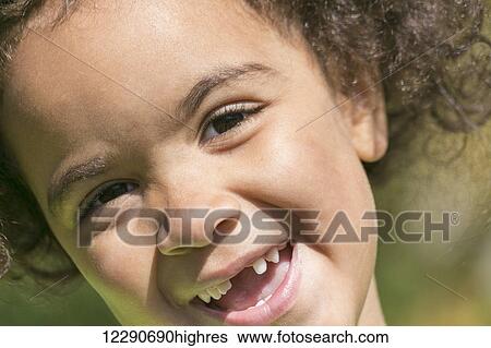 Stock Photograph - Close up portrait of a young girl with teeth missing in her smile; Edmonton, Alberta, Canada. Fotosearch