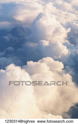 Stock Photograph - Cloud formations lit up by the setting sun over the North Atlantic; Anchorage, Alaska, United States of America. Fotosearch