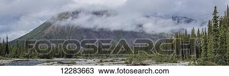 Clouds cover the tops of the mountains along the Wind River in the Peel watershed; Yukon, Canada View Large Photo Image Stock Image - Clouds cover the tops of the mountains along the Wind River in the Peel watershed; Yukon, Canada. Fotosearch