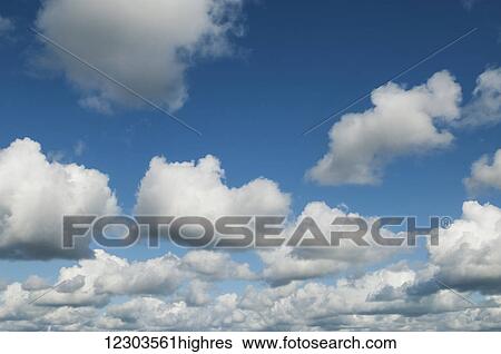 Stock Photograph - Clouds in a blue sky; Alaska, United States of America. Fotosearch