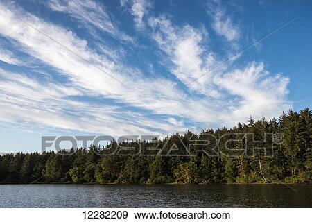 Clouds pass above Coffenbury Lake; Hammond, Oregon, United States of America View Large Photo Image Stock Photo - Clouds pass above Coffenbury Lake; Hammond, Oregon, United States of America. Fotosearch