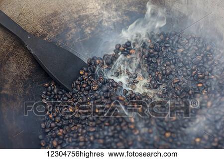 Coffee beans being roasted by hand in a wok by the coffee pickers; Sumatra, Indonesia View Large Photo Image Stock Photograph - Coffee beans being roasted by hand in a wok by the coffee pickers; Sumatra, Indonesia. Fotosearch