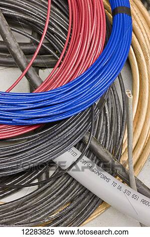 Stock Photography - Coils of cable and cord hanging on a wall at an electrical power plant, Sand Point, Southwestern Alaska, USA. Fotosearch