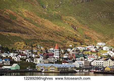 Stock Photograph - Colorful houses in a village along the coast; Siglufjordur, Iceland. Fotosearch