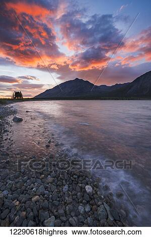 Stock Photograph - Colors of sunset fill the sky over upper Twin Lake in Lake Clark National Park & Preserve, Alaska.. Fotosearch