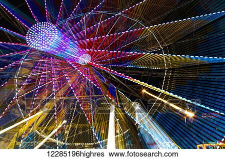 Colourful lights of a moving ferris wheel at nighttime; Calgary, Alberta, Canada View Large Photo Image Stock Photograph - Colourful lights of a moving ferris wheel at nighttime; Calgary, Alberta, Canada. Fotosearch