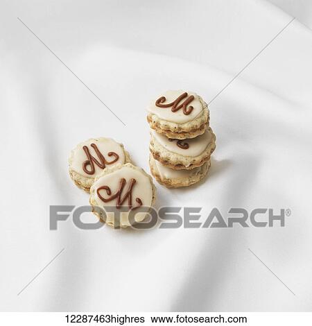 Stock Photograph - Cookies with the letter M on top; Toronto, Ontario, Canada. Fotosearch