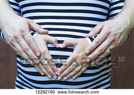 Stock Image - Couple expecting a baby; Langley, British Columbia, Canada. Fotosearch