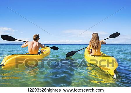 Stock Photograph - Couple Kayaking in the Ocean on Vacation. Fotosearch