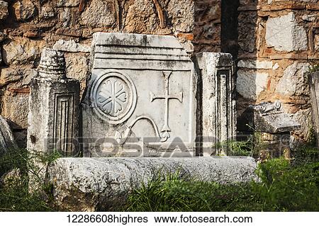 Stock Photograph - Cracked stone structure with a cross; Delphi, Greece. Fotosearch