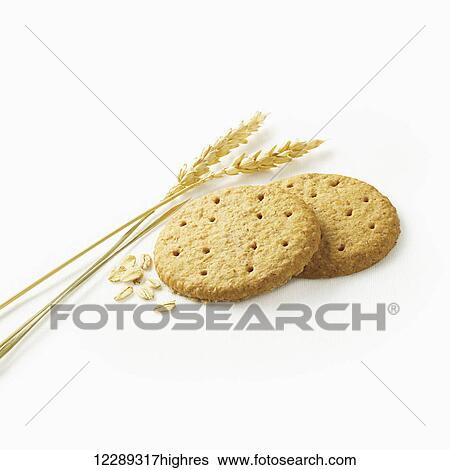 Stock Photograph - Crackers with grains on a white background; Toronto, Ontario, Canada. Fotosearch
