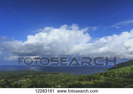 Stock Image - Cumulus clouds over historic Kealakeku Bay, site of Captain CookÃƒÂ¢Ã¢â€šÂ¬Ã¢â€žÂ¢s death and monument; Kona, Island of Hawaii, Hawaii, United States of America. Fotosearch