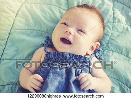 Stock Photograph - Cute newborn baby girl smiling. Fotosearch