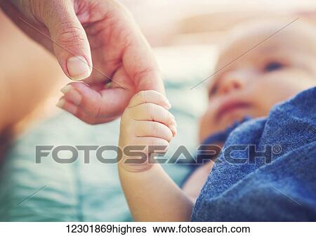 Cute newborn baby holding mother's hand View Large Photo Image Stock Photograph - Cute newborn baby holding mother's hand. Fotosearch