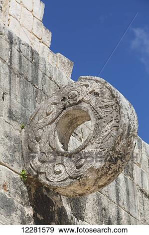 Stock Photo - Decorated stone ring, The Grand Ball Court, Chichen Itza; Yucatan, Mexico. Fotosearch