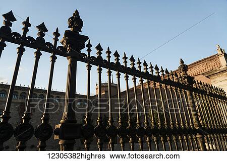 Decorative fence beside buildings of Archbishop's palace in Alcala de Henares, a historical and charming city near to Madrid; Alcala de Henares, Spain View Large Photo Image Stock Photograph - Decorative fence beside buildings of Archbishop's palace in Alcala de Henares, a historical and charming city near to Madrid; Alcala de Henares, Spain. Fotosearch