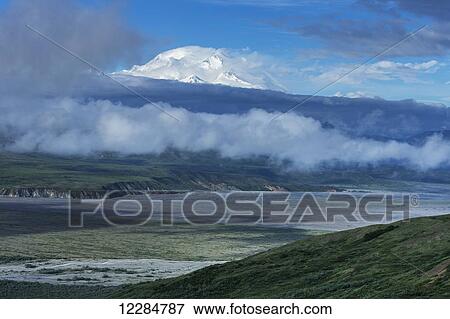 Denali emerges from morning mist as seen from Eielson Visitor Center, Denali National Park; Alaska, United States of America View Large Photo Image Stock Photo - Denali emerges from morning mist as seen from Eielson Visitor Center, Denali National Park; Alaska, United States of America. Fotosearch