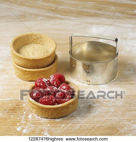 Dessert cups on a floured surface with raspberries in one, and a round cookie cutter; Toronto, Ontario, Canada View Large Photo Image Stock Photograph - Dessert cups on a floured surface with raspberries in one, and a round cookie cutter; Toronto, Ontario, Canada. Fotosearch