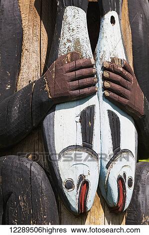 Detail of a figure holding salmon carved into a totem pole, Totem Bight State Historical Park, Ketchikan, Southeast Alaska, USA, Spring View Large Photo Image Stock Photograph - Detail of a figure holding salmon carved into a totem pole, Totem Bight State Historical Park, Ketchikan, Southeast Alaska, USA, Spring. Fotosearch