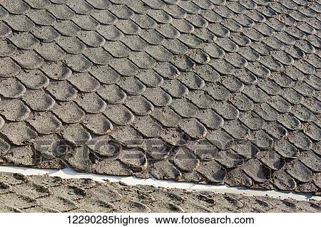 Stock Photograph - Detail of old well worn rounded roof shingles; Calgary, Alberta, Canada. Fotosearch