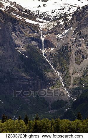 Stock Photograph - Distant mountain waterfall and cascading stream tumbling down the mountainside; Colorado, United States of America. Fotosearch