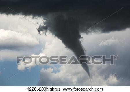 Dramatic funnel cloud created in dark storm clouds; Calgary, Alberta, Canada View Large Photo Image Stock Photograph - Dramatic funnel cloud created in dark storm clouds; Calgary, Alberta, Canada. Fotosearch