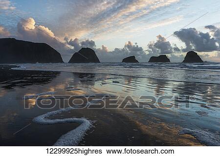 Stock Photograph - Dusk approaches on Crescent Beach; Cannon Beach, Oregon, United States of America. Fotosearch