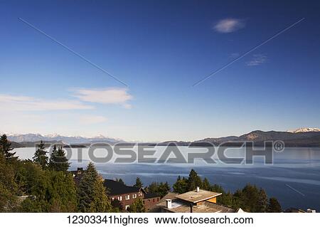 Stock Photograph - Early morning light on a large lake of Patagonia; Bariloche, Argentina. Fotosearch