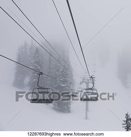 Empty chairlift at a ski resort in fog; Whistler, British Columbia, Canada View Large Photo Image Stock Photograph - Empty chairlift at a ski resort in fog; Whistler, British Columbia, Canada. Fotosearch