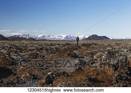 Stock Photograph - Exploring the icy underground lava caves in the Blafjoll mountain range; Blafjoll, Iceland. Fotosearch