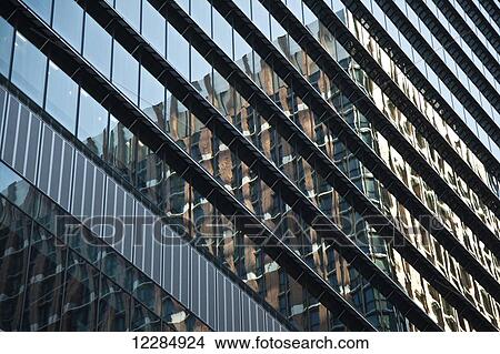 Picture - Facade of a building with glass walls and another building reflected in the glass; Tokyo, Japan. Fotosearch