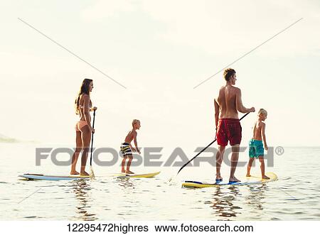 Family Having Fun Stand Up Paddling Together in the Ocean on Beautiful Sunny Morning View Large Photo Image Stock Photograph - Family Having Fun Stand Up Paddling Together in the Ocean on Beautiful Sunny Morning. Fotosearch