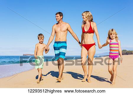 Stock Photograph - Family vacation. Happy family having fun on beautiful warm sunny beach. Outdoor summer lifestyle.. Fotosearch