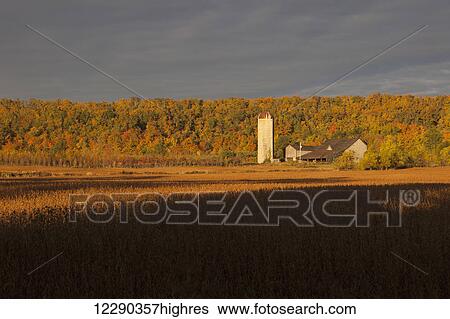 Stock Photograph - Farm field, barn and autumn colors at dawn; Milton, Ontario, Canada. Fotosearch