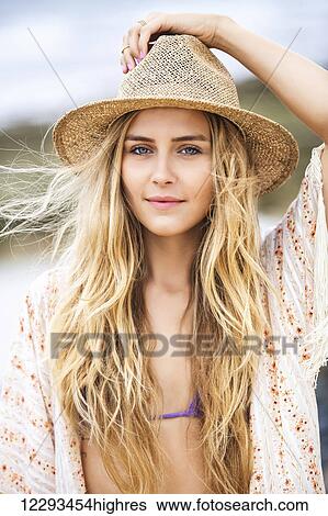 Fashion lifestyle, Attractive woman in bikini and sun hat at the beach View Large Photo Image Stock Photograph - Fashion lifestyle, Attractive woman in bikini and sun hat at the beach. Fotosearch