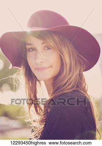 Fashion portrait of young beautiful woman in hat, bright warm sunny colors View Large Photo Image Stock Photograph - Fashion portrait of young beautiful woman in hat, bright warm sunny colors. Fotosearch