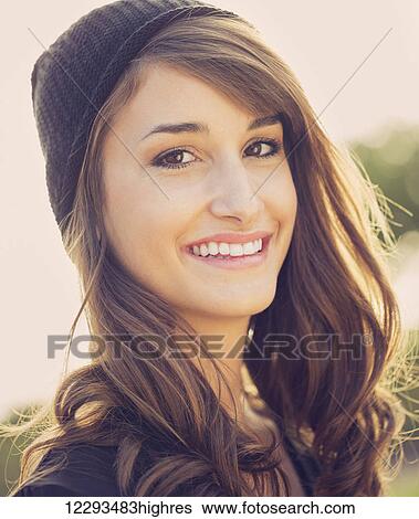 Stock Photograph - Fashion portrait of young beautiful woman outside, bright warm sunny color tones. Fotosearch