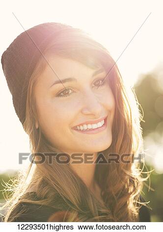 Stock Photograph - Fashion portrait of young beautiful woman outside, bright warm sunny color tones. Fotosearch