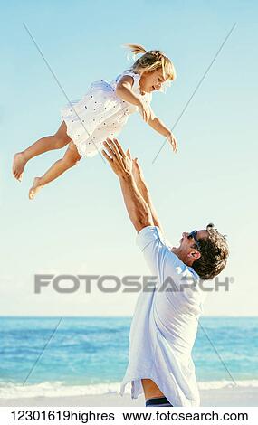 Stock Photograph - Father and Daughter Having Fun at the Beach. Fotosearch