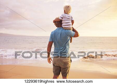 Stock Photograph - Father and son playing at sunset. Fotosearch